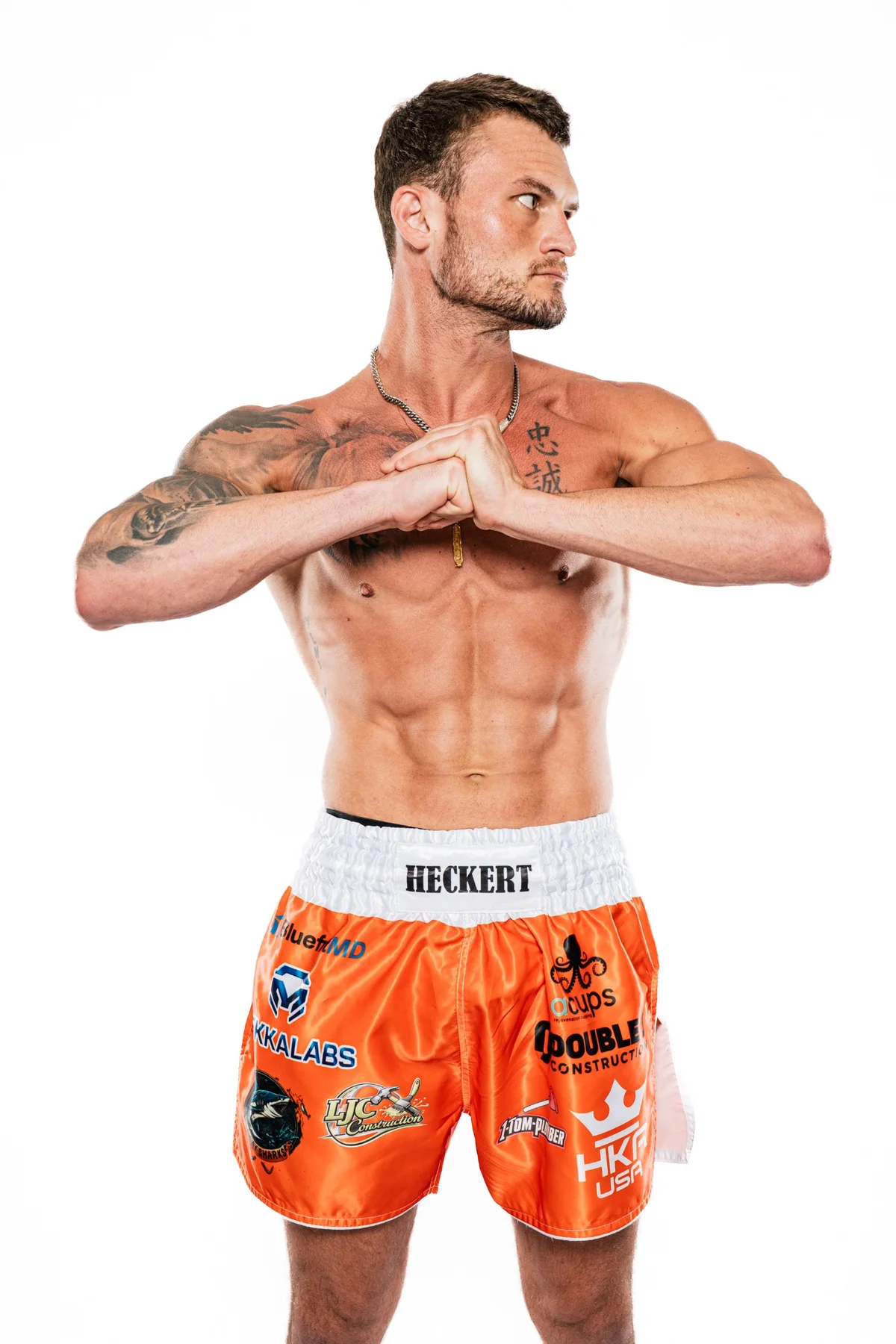 Michael Heckert in a studio portrait wearing his fight shorts